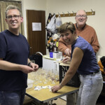 Folding up the raffle tickets - Kev, Debbie, and Phil.
