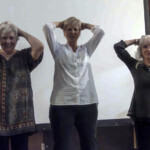 Fiona, Mandy, and Su demonstrating how to put your hands on your head (how to play True or False).