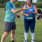 Mike presents Vikki with her completion medal